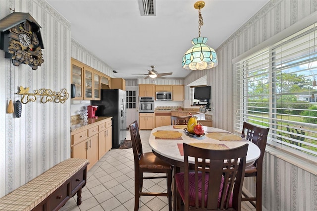 6801 Pinellas Point Dr S, Saint Petersburg, FL 33712 - dining space featuring wallpapered walls, light tile patterned flooring, and a ceiling fan