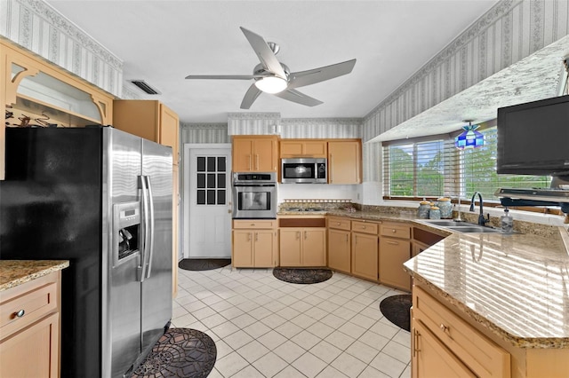 6801 Pinellas Point Dr S, Saint Petersburg, FL 33712 - kitchen with wallpapered walls, stainless steel appliances, a sink, light brown cabinets, and ceiling fan