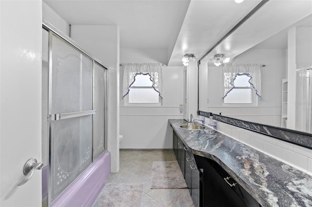6801 Pinellas Point Dr S, Saint Petersburg, FL 33712 - bathroom with toilet, plenty of natural light, double vanity, and shower / bath combination with glass door