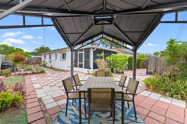 6801 Pinellas Point Dr S, Saint Petersburg, FL 33712 - fenced backyard featuring a sunroom, a patio area, outdoor dining space, and grilling area