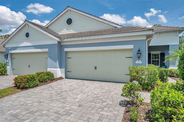 12817 Cobalt Ter, Bradenton, FL 34211 - view of front facade with stucco siding, decorative driveway, and an attached garage
