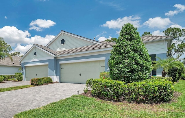 12817 Cobalt Ter, Bradenton, FL 34211 - ranch-style house with decorative driveway, stucco siding, an attached garage, and a tile roof