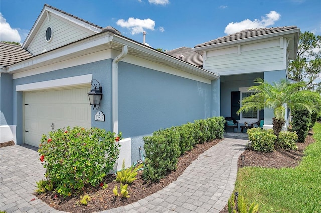 12817 Cobalt Ter, Bradenton, FL 34211 - view of property exterior with a garage, stucco siding, a tiled roof, and driveway