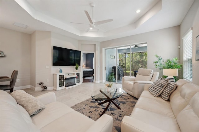 12817 Cobalt Ter, Bradenton, FL 34211 - living area featuring a tray ceiling, ceiling fan, and healthy amount of natural light