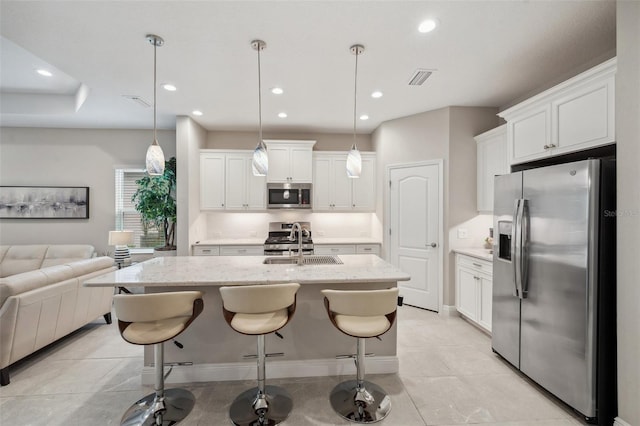 12817 Cobalt Ter, Bradenton, FL 34211 - kitchen with stainless steel appliances, a sink, open floor plan, recessed lighting, and white cabinets