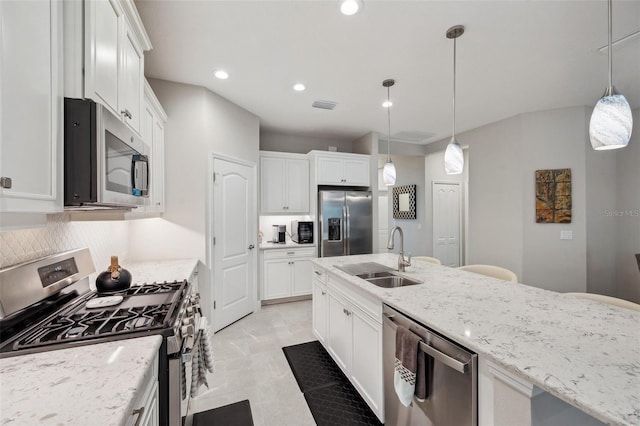 12817 Cobalt Ter, Bradenton, FL 34211 - kitchen featuring stainless steel appliances, a sink, white cabinets, decorative backsplash, and recessed lighting