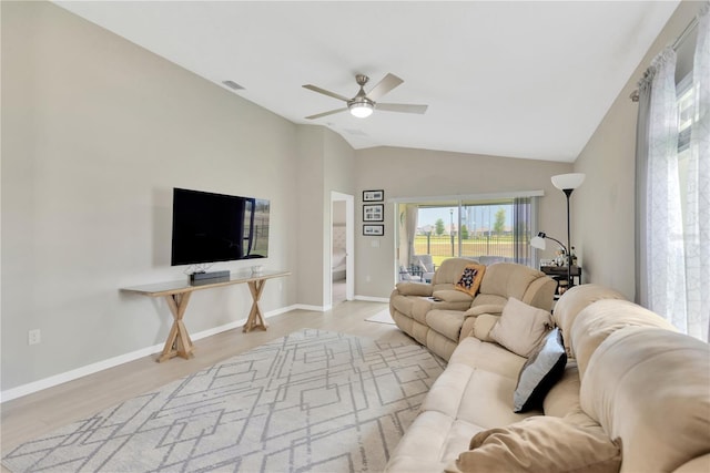 living area featuring ceiling fan, wood finished floors, lofted ceiling, and baseboards