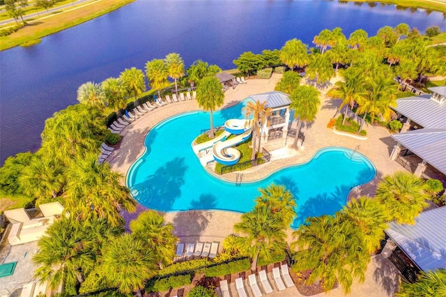 drone / aerial view of a pool and a large body of water