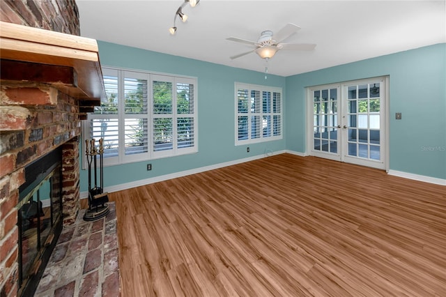 6536 115th Ln, Seminole, FL 33772 - unfurnished living room featuring french doors, a ceiling fan, a fireplace, and baseboards