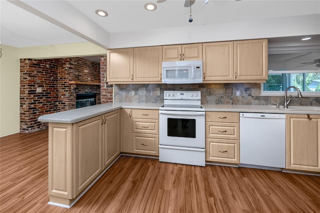 6536 115th Ln, Seminole, FL 33772 - kitchen with white appliances, a sink, light brown cabinets, wood finished floors, and recessed lighting
