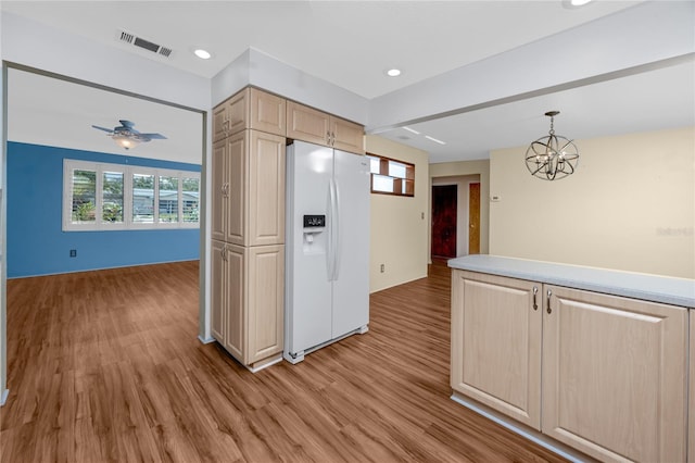 6536 115th Ln, Seminole, FL 33772 - kitchen featuring white fridge with ice dispenser, a chandelier, plenty of natural light, light wood-style flooring, and recessed lighting