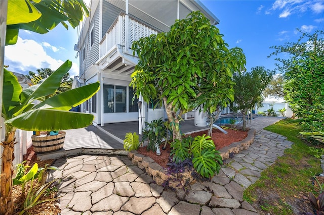 6536 115th Ln, Seminole, FL 33772 - view of side of home featuring a balcony, a patio, fence, and a wooden deck