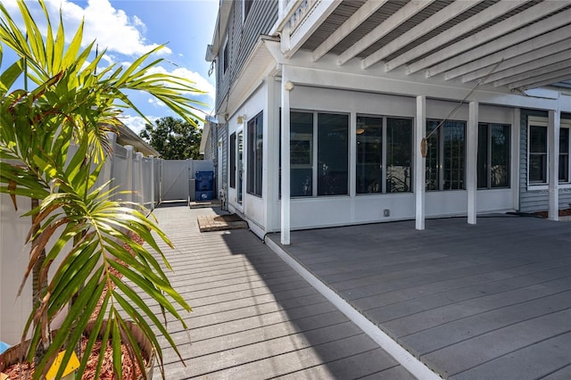 6536 115th Ln, Seminole, FL 33772 - wooden terrace featuring fence, a gate, and a sunroom