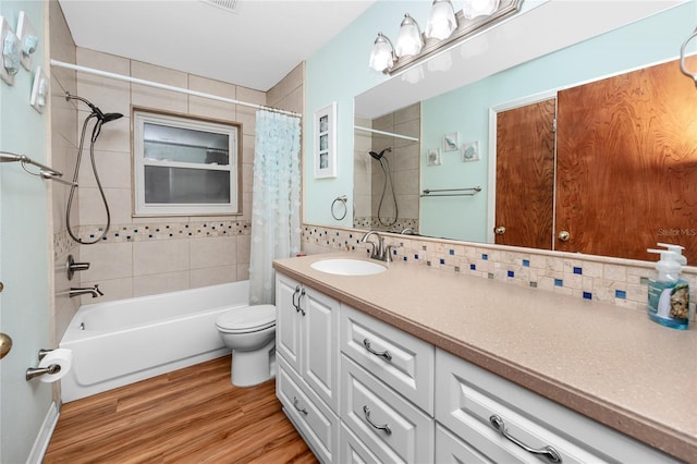 6536 115th Ln, Seminole, FL 33772 - full bathroom featuring decorative backsplash, shower / bathtub combination with curtain, wood finished floors, and vanity