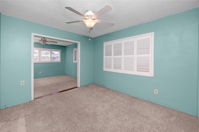 6536 115th Ln, Seminole, FL 33772 - unfurnished bedroom featuring carpet floors, a ceiling fan, and a textured ceiling