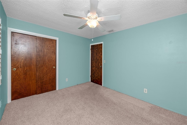 6536 115th Ln, Seminole, FL 33772 - unfurnished bedroom featuring a closet, carpet, ceiling fan, and a textured ceiling