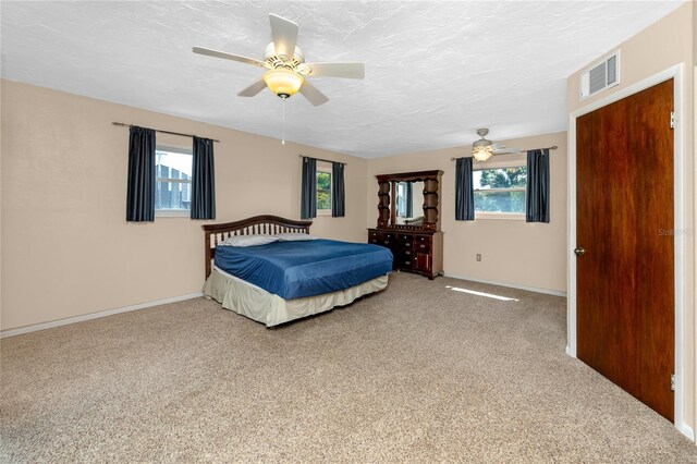 6536 115th Ln, Seminole, FL 33772 - carpeted bedroom featuring baseboards, ceiling fan, and a textured ceiling