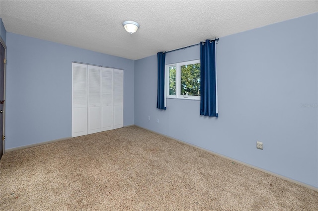 6536 115th Ln, Seminole, FL 33772 - unfurnished bedroom with a closet, carpet flooring, a textured ceiling, and baseboards