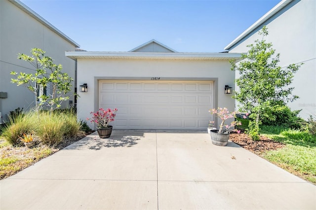 13614 Stevenson Ln, Odessa, FL 33556 - view of front of home featuring stucco siding, driveway, and an attached garage
