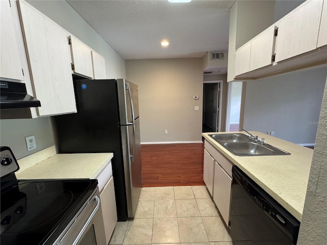 13243 Sanctuary Cove Dr Unit 204, Temple Terrace, FL 33637 - kitchen with stainless steel range with electric cooktop, black dishwasher, under cabinet range hood, a sink, and light countertops