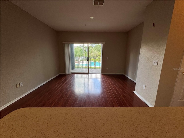 13243 Sanctuary Cove Dr Unit 204, Temple Terrace, FL 33637 - unfurnished room with wood finished floors, baseboards, and a textured wall