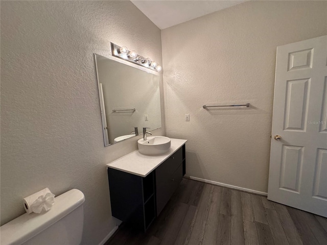 13243 Sanctuary Cove Dr Unit 204, Temple Terrace, FL 33637 - bathroom featuring toilet, wood finished floors, vanity, and a textured wall