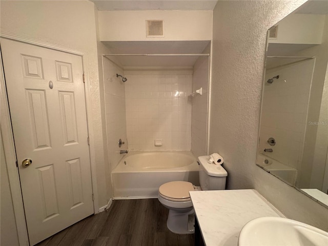 13243 Sanctuary Cove Dr Unit 204, Temple Terrace, FL 33637 - full bathroom featuring a textured wall, wood finished floors, shower / washtub combination, toilet, and vanity