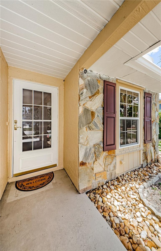699 Merlins Ct, Tarpon Springs, FL 34689 - doorway to property featuring stone siding