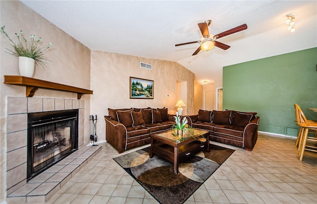 699 Merlins Ct, Tarpon Springs, FL 34689 - living area featuring ceiling fan, light tile patterned floors, a tile fireplace, baseboards, and lofted ceiling