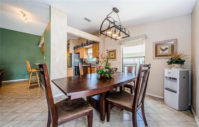 699 Merlins Ct, Tarpon Springs, FL 34689 - dining area featuring light tile patterned floors and baseboards