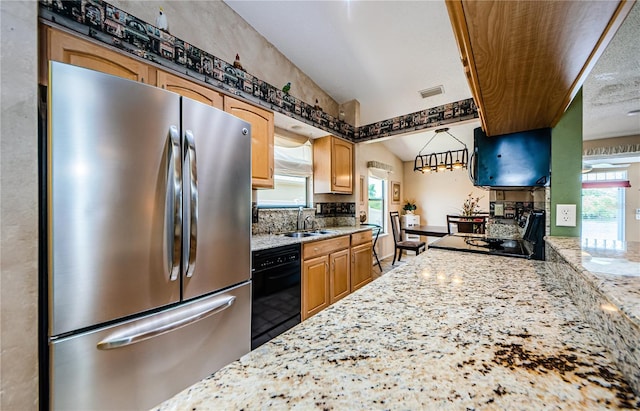 699 Merlins Ct, Tarpon Springs, FL 34689 - kitchen featuring freestanding refrigerator, black dishwasher, a sink, light stone counters, and backsplash
