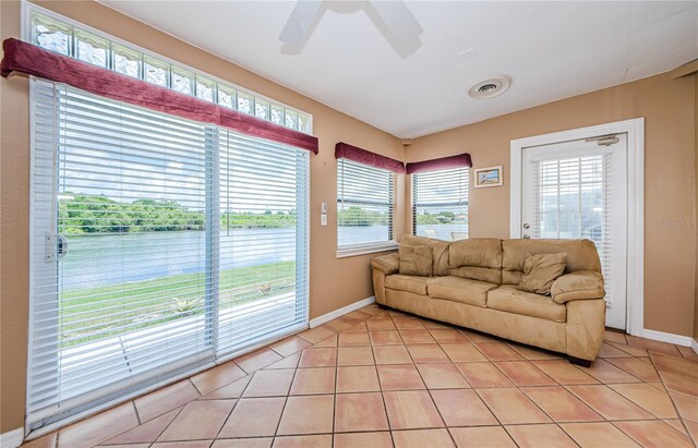 699 Merlins Ct, Tarpon Springs, FL 34689 - living room with healthy amount of natural light, a ceiling fan, and light tile patterned flooring