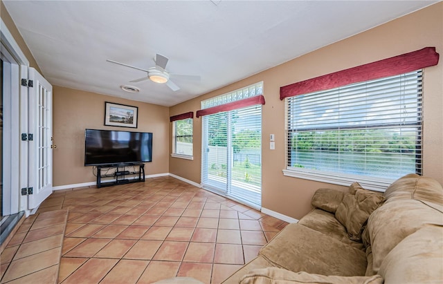 699 Merlins Ct, Tarpon Springs, FL 34689 - living room with light tile patterned flooring, ceiling fan, and baseboards