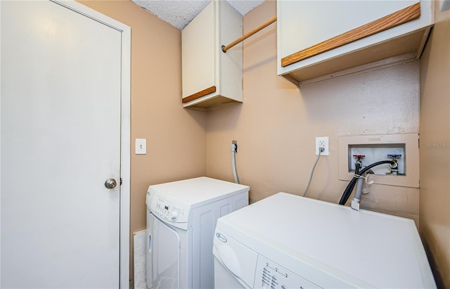 699 Merlins Ct, Tarpon Springs, FL 34689 - laundry area featuring cabinet space, washing machine and dryer, and a textured ceiling