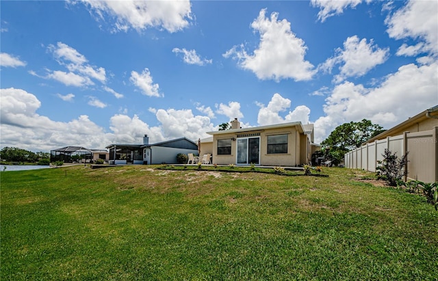 699 Merlins Ct, Tarpon Springs, FL 34689 - rear view of property featuring a chimney and stucco siding