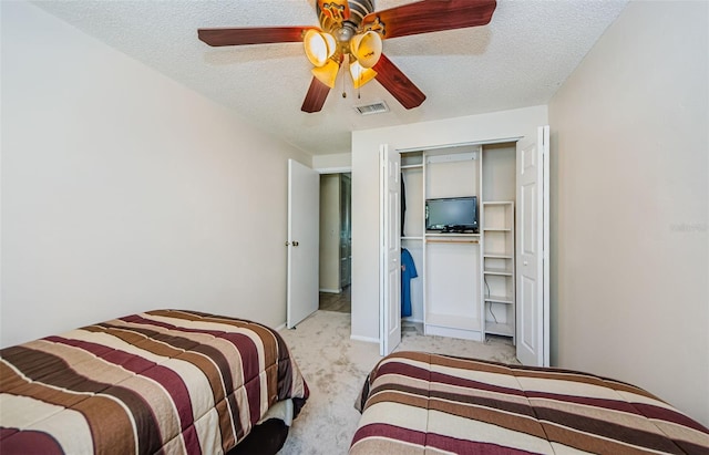 699 Merlins Ct, Tarpon Springs, FL 34689 - carpeted bedroom with a closet, a textured ceiling, and ceiling fan