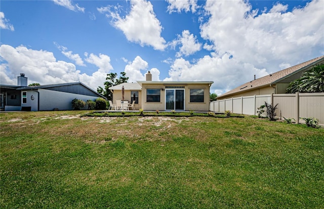 699 Merlins Ct, Tarpon Springs, FL 34689 - back of property with a chimney and a patio area