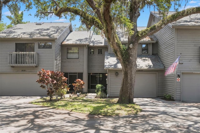 2033 Arbor Dr, Clearwater, FL 33760 - multi unit property with a garage, concrete driveway, and a shingled roof
