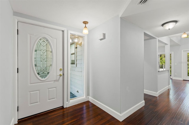 2033 Arbor Dr, Clearwater, FL 33760 - entryway with baseboards and dark wood-type flooring