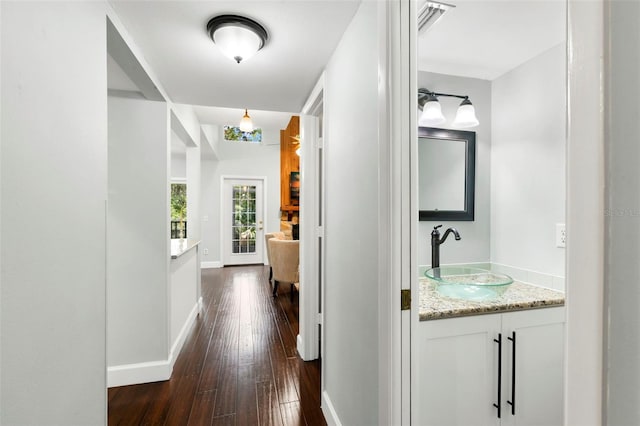 2033 Arbor Dr, Clearwater, FL 33760 - corridor featuring a sink, dark wood-type flooring, and baseboards