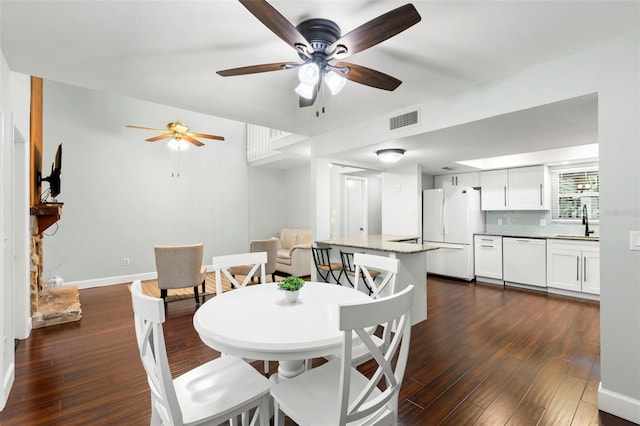 2033 Arbor Dr, Clearwater, FL 33760 - dining room with dark wood-type flooring, ceiling fan, and baseboards