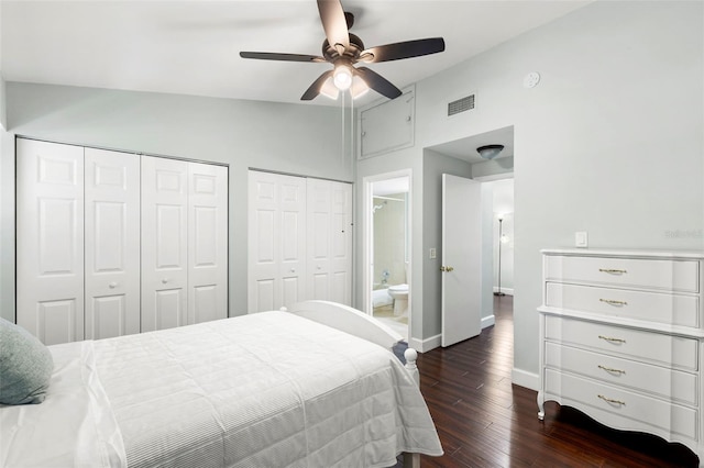 2033 Arbor Dr, Clearwater, FL 33760 - bedroom featuring lofted ceiling, dark wood-style floors, baseboards, multiple closets, and a ceiling fan