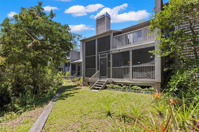 2033 Arbor Dr, Clearwater, FL 33760 - rear view of house with a sunroom, a yard, and a chimney