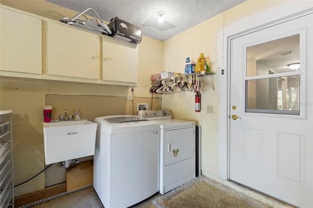 2033 Arbor Dr, Clearwater, FL 33760 - washroom featuring cabinet space, separate washer and dryer, and a textured ceiling
