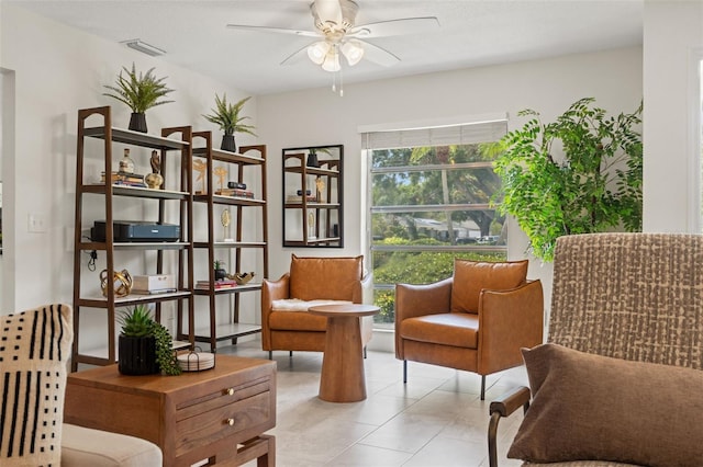 living area featuring a ceiling fan and light tile patterned floors