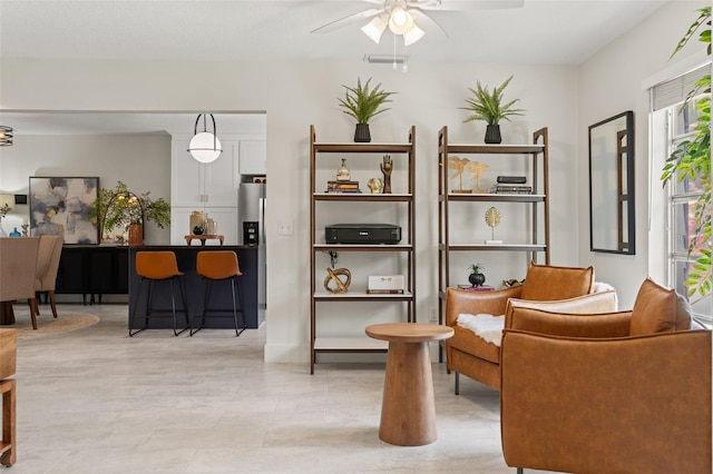sitting room with a ceiling fan
