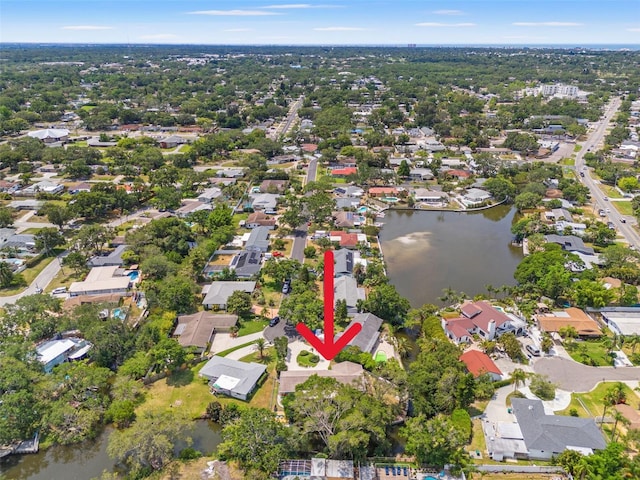 view of property location with a nearby body of water and nearby suburban area