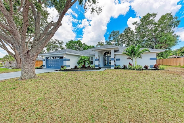 3330 46th Ter E, Bradenton, FL 34203 - ranch-style home featuring stucco siding, driveway, a garage, and french doors