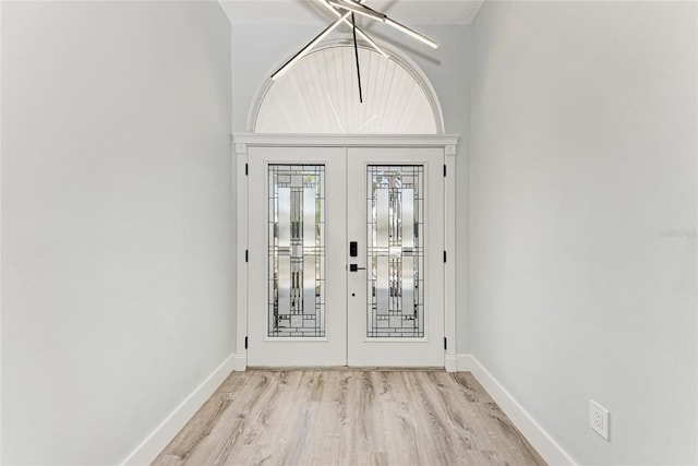 3330 46th Ter E, Bradenton, FL 34203 - foyer featuring french doors, light wood finished floors, and baseboards