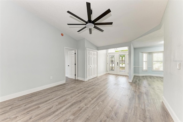 3330 46th Ter E, Bradenton, FL 34203 - unfurnished living room featuring vaulted ceiling, wood finished floors, baseboards, and ceiling fan